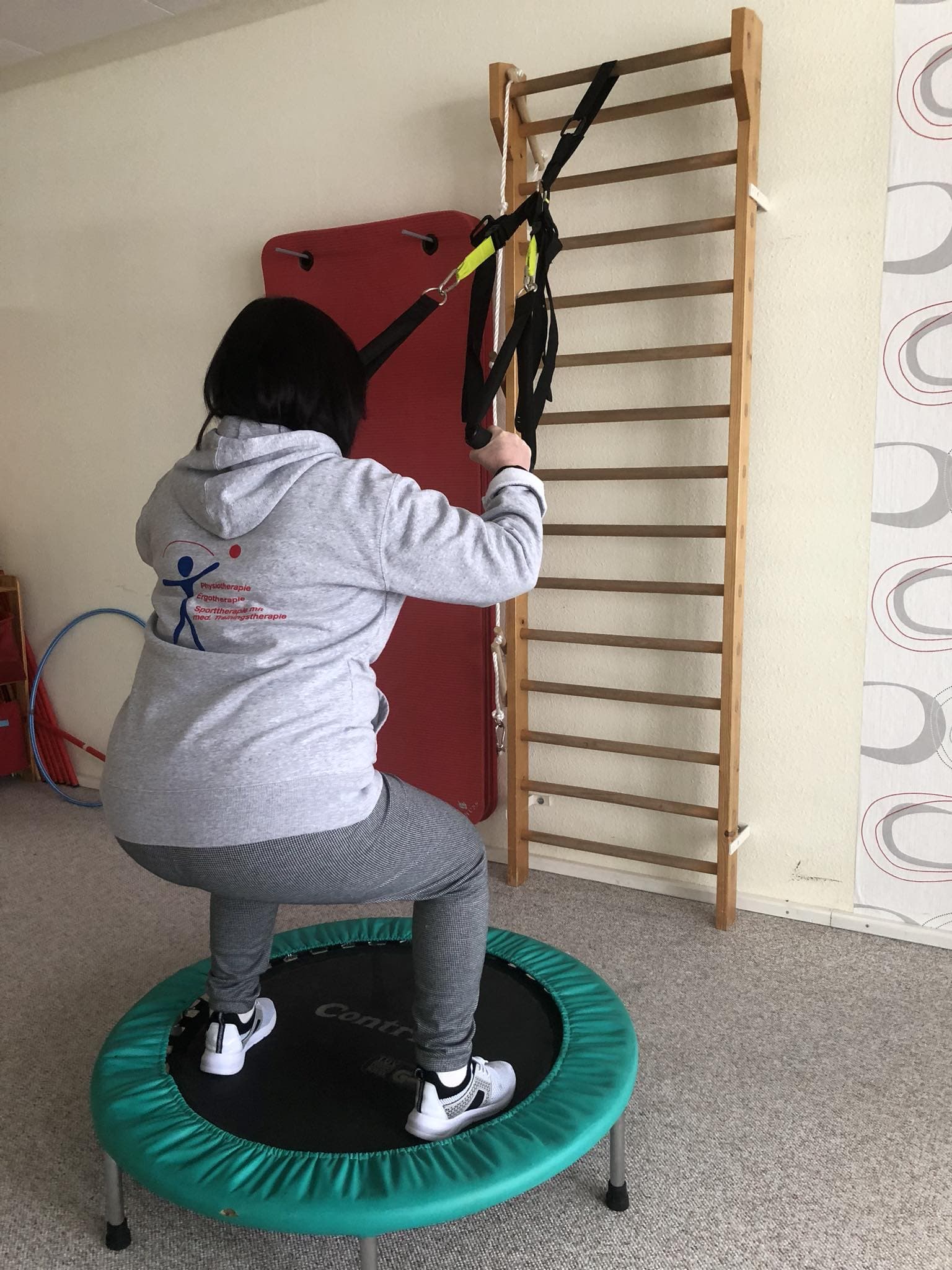 Patient beim TRX-Training auf dem Trampolin