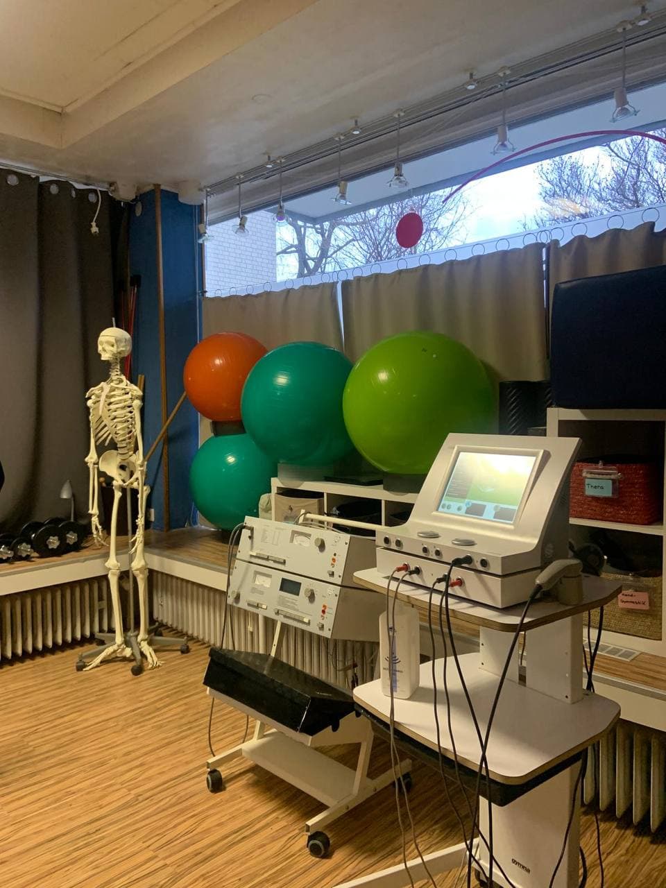 Therapieraum mit Skelettmodell, Gymnastikbällen und Behandlungsgeräten